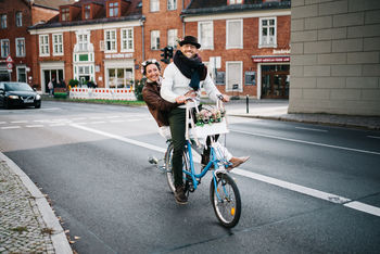 PEOPLE RIDING BICYCLES ON ROAD IN CITY