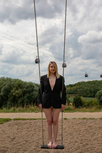 Full length of woman on swing in playground