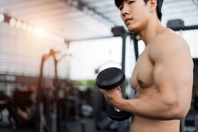 Close-up of muscular man exercising in gym