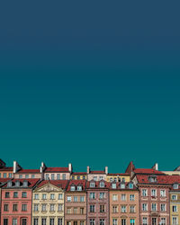 Low angle view of buildings against clear blue sky