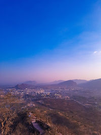 High angle view of buildings against blue sky