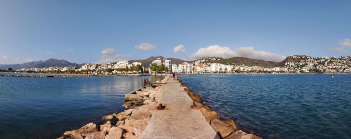 Panoramic view of sea and buildings against sky