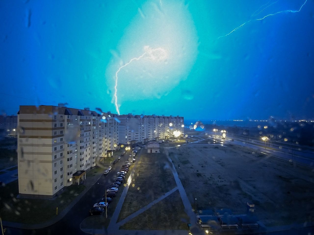 AERIAL VIEW OF ILLUMINATED CITYSCAPE AT NIGHT