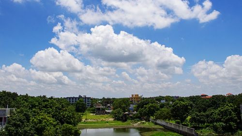 Panoramic view of trees and buildings against sky