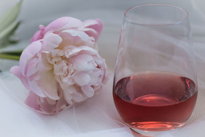 Close-up of pink rose in cup on table