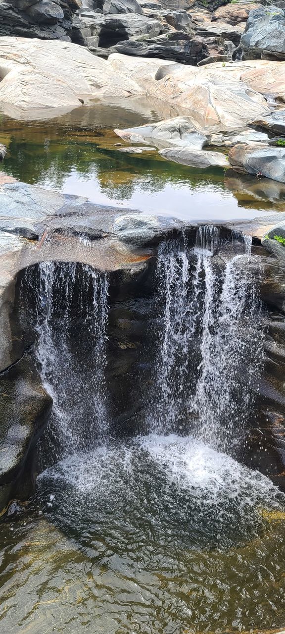 waterfall, water, water feature, motion, nature, rock, beauty in nature, day, no people, splashing, outdoors, flowing water, formation, scenics - nature, body of water, winter, rock formation, ice, land, sports, spring, long exposure