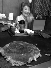 Woman holding ice cream on table