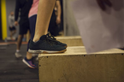 Low section of woman wearing canvas shoes