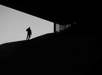 Silhouette of man walking against the sky