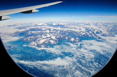 Aerial view of airplane wing over landscape