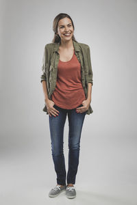 Portrait of smiling young woman against white background