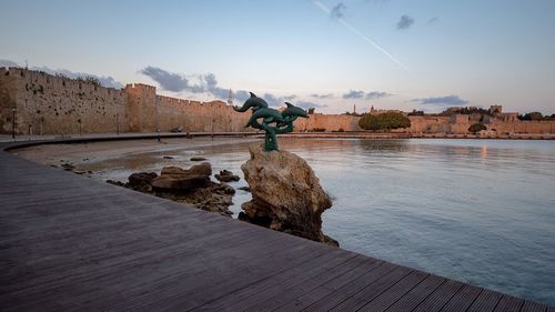 Man on shore against sky