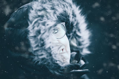 Close-up portrait of young woman during winter