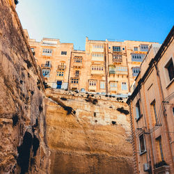 Low angle view of buildings against blue sky