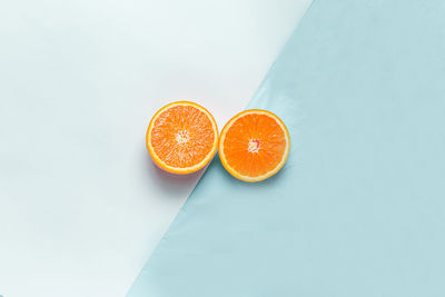 High angle view of orange fruit against white background