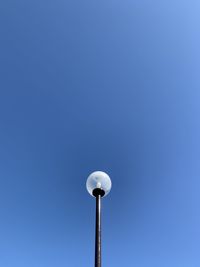 Low angle view of street light against clear blue sky