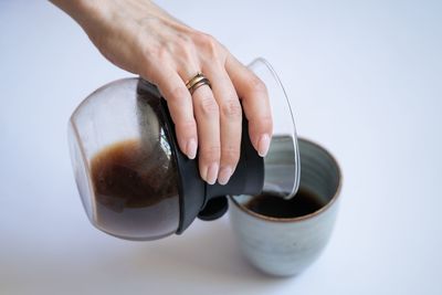 Midsection of man holding coffee cup