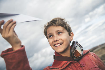 Portrait of smiling boy holding camera