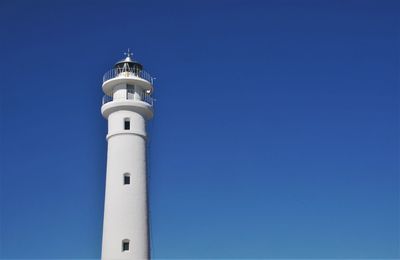 Low angle view of lighthouse of punta roncadoira against clear blue sky