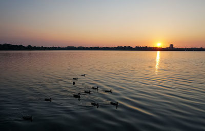 Scenic view of lake against sky during sunset