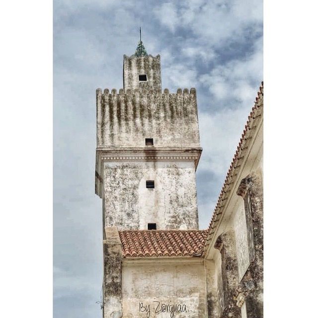 architecture, built structure, building exterior, low angle view, transfer print, sky, auto post production filter, tower, cloud - sky, church, religion, clock tower, history, day, place of worship, cloud, old, cloudy, tall - high