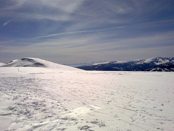 Scenic view of snow covered mountains against sky