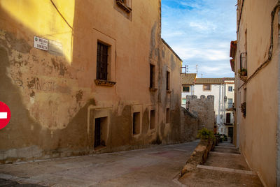 Street amidst buildings in city against sky