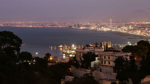 High angle view of illuminated buildings in city at night