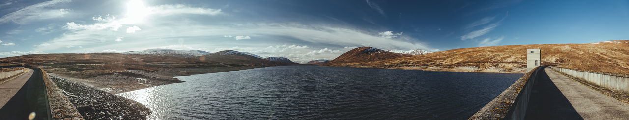 Panoramic view of dam amidst sea against sky