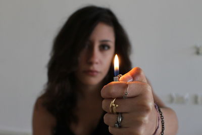 Portrait of young woman holding candle