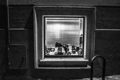 People sitting on window of building