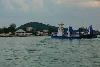 Scenic view of sea by buildings against sky