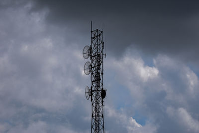 Low angle view of communications tower against sky