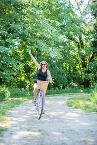 Woman riding bicycle on tree