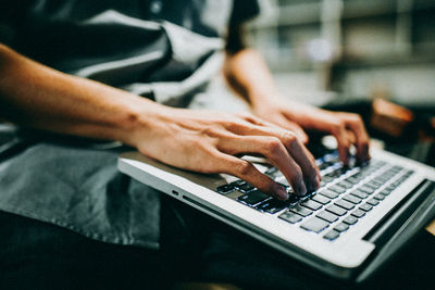 Midsection of man using laptop