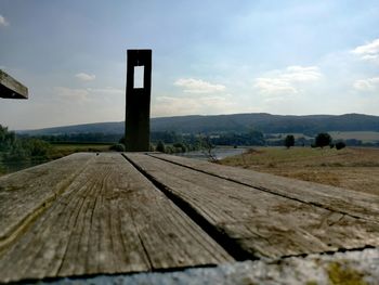 Railroad track against cloudy sky