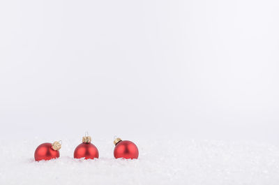 Close-up of christmas decorations over snow