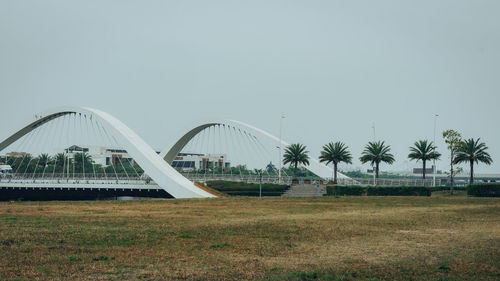 Bridge over field against clear sky