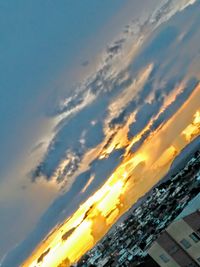 Low angle view of buildings against sky during sunset