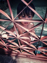 High angle portrait of cute shirtless girl seen through window