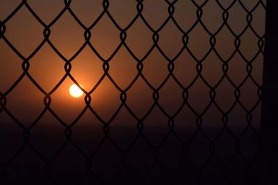  chainlink fence against sunset sky