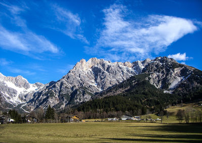 Scenic view of snowcapped mountains against blue sky