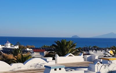 High angle view of swimming pool by sea against clear sky