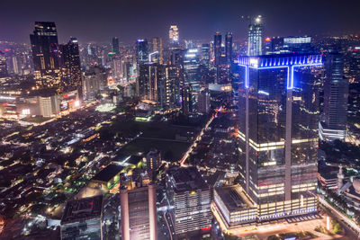 Aerial view of city lit up at night