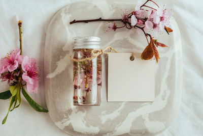 Directly above shot of essential oil and flowers on table