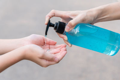 Close-up of woman hand holding bottle