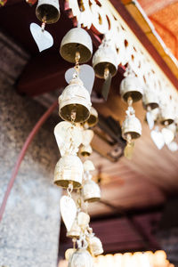 Low angle view of electric lamp hanging on ceiling