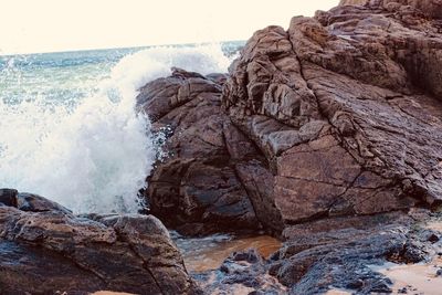 Waves splashing on rocks at shore