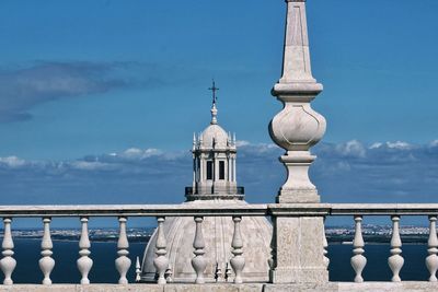 View of white building against cloudy sky