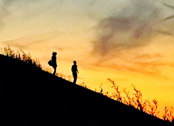 Silhouette of people at sunset